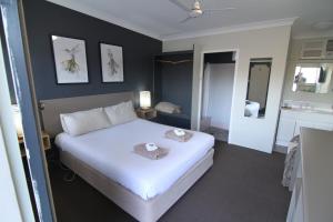 米塔贡梅尔罗斯汽车旅馆 的卧室配有一张白色大床
