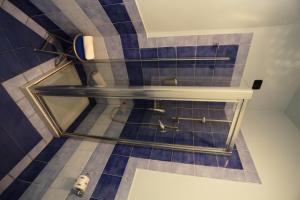 雷焦卡拉布里亚阿尔巴努欧瓦酒店的铺有瓷砖地板,设有带玻璃架的浴室