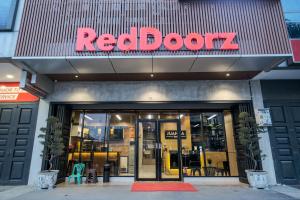 棉兰RedDoorz Plus @ Jalan Juanda Medan的红色门店,上面有红色标志