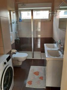 萨格勒布Apartman EVA ZAGREB的浴室配有卫生间水槽和洗衣机。