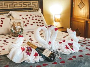 贡萨尔维斯艾斯贝洛达瓜旅馆的两天鹅,床上有一瓶香槟