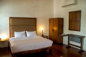 乔治市任伊唐文化酒店的卧室配有白色大床和橱柜