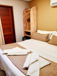 费尔南多 - 迪诺罗尼亚雷肯托旅馆的一张白色的床,上面有两条毛巾