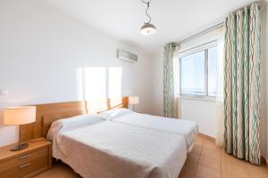 蒙蒂戈杜La Francesa Algarve的一间卧室设有一张床和一个窗口