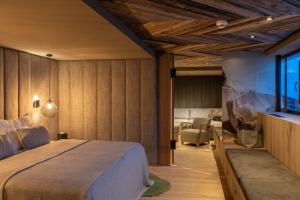 上陶恩Das Kohlmayr Superior的一间卧室设有一张床和一间客厅。