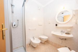 莫埃纳Flos Hotel的浴室配有卫生间、盥洗盆和淋浴。
