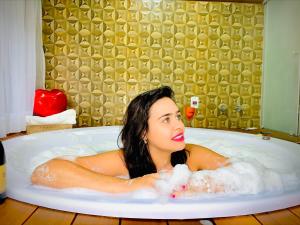蒙特韦尔迪Estalagem da Montanha的躺在泡沫浴缸中的女人