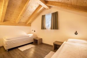 圣维吉利奥Apartment Sis Residence Bun Ste的配有木天花板的客房设有两张床。