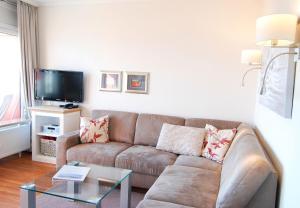 格洛米茨STRANDIDYLL, 64 - Typ A1S的客厅配有棕色沙发和电视