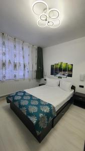 托普利察Apartament Fodor的一间卧室配有一张床和一个吊灯