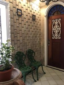 马塞约Casa da Josi - Pajuçara的两把绿色椅子,位于带门的房间