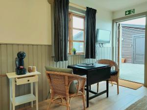 海拉Riverfront Lodge Hella的一间带桌椅和窗户的用餐室