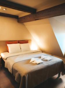 文茨皮尔斯库弗南斯酒店的一间卧室配有一张床,上面有两条毛巾