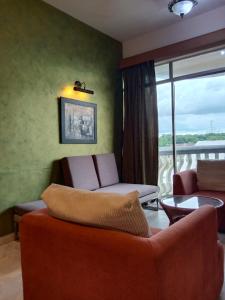 波德申Glory beach resort private apartment的带沙发的客厅和阳台