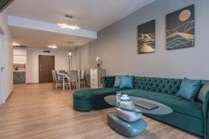 布尔加斯Green Luxury Apartments的客厅配有绿色沙发和桌子