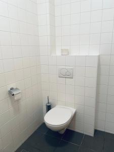 KleinmariazellStiftstaverne Klein Mariazell的白色瓷砖墙内带卫生间的浴室