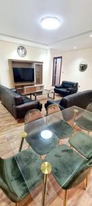 迪拜HAVANA HOLIDAY HOMES MIRDIF的客厅配有玻璃桌和椅子