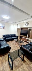 迪拜HAVANA HOLIDAY HOMES MIRDIF的带沙发和平面电视的客厅