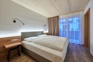 萨尔巴赫克里斯蒂娜旅馆的一间卧室设有一张大床和一个窗户。