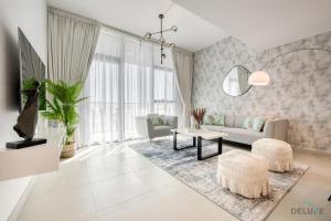 迪拜Alluring 1BR at The Pulse Blvd C3 Dubai South by Deluxe Holiday Homes的客厅配有沙发和桌子