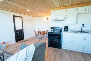洋滨市Tidal House #10 - Ocean Shores Chalet的厨房配有白色橱柜和桌椅