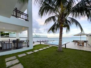 MkunguniZanzibar DT Beachfront Villa的棕榈树和游泳池的房子
