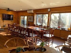沼津遙かな亭的用餐室配有大型木桌和椅子