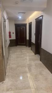 吉达PRIMOTEL Elite As Salamah的走廊设有两扇门,铺有瓷砖地板