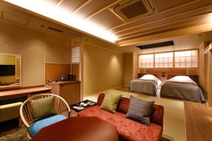 龟冈京汤之花翠泉日式旅馆的酒店客房,设有两张床和一张沙发