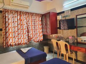 钦奈HOTEL GREENS - Puratchi Thalaivar Dr M G Ramachandran Central Railway Station Chennai的厨房配有桌椅和窗户。
