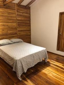 圣维森特Casa de Paz的一间卧室配有一张木墙床