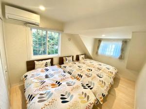 轻井泽Polar House ShinKaruisawa1 - Vacation STAY 00271v的一间卧室设有两张床和窗户。