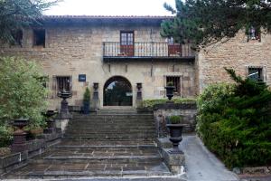贝里奥帕拉诺Hotel Luze El Toro的一座古老的石头房子,设有通往门的楼梯