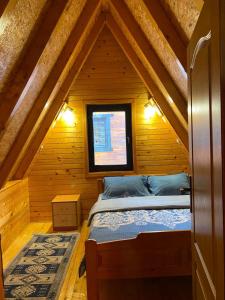 扎布利亚克Holiday Home Vojinovic的木制阁楼卧室配有一张床