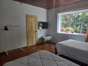 洛哈Villa Amada a place to relax and take a rest的一间卧室设有两张床和窗户。