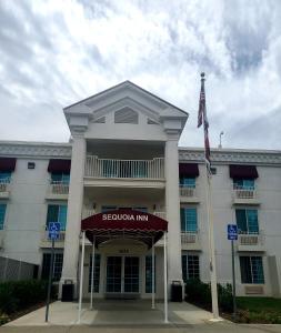 汉福德红杉汽车旅馆的前面有旗帜的大型白色建筑