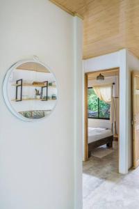 圣塔特蕾莎海滩Ambar House的带镜子的房间和一间带床的卧室