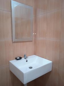 丹戎槟榔Madu Tiga Beach and Resort的浴室设有白色水槽和镜子