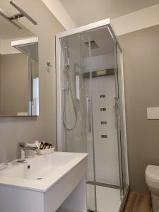 科内利亚诺克里斯塔罗酒店的带淋浴和白色盥洗盆的浴室