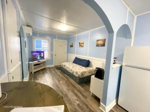 太平洋城The Anchorage Motel的小房间设有床铺和电视