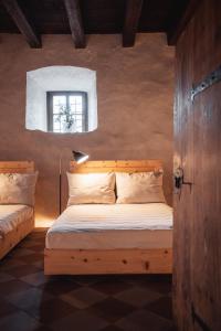 圣洛伦佐-迪塞巴托Castel Maurn的一间卧室设有一张木床和一个窗户。