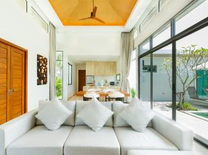 邦涛海滩Ananas villa Shambala grand Cherng Talay的客厅配有带枕头的白色沙发