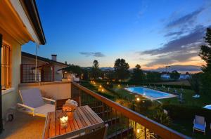 加达湖畔帕登赫Italia Living Villa的一个带桌子和游泳池的阳台