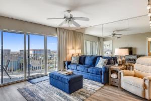 沃尔顿堡滩Seacrest 610 is a 2 BR Gulfside on Okaloosa Island condo的客厅设有蓝色的沙发和大窗户