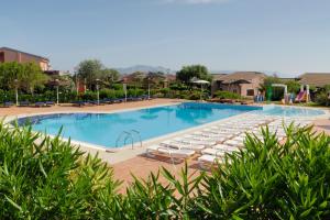 斯廷蒂诺卡拉罗莎俱乐部酒店的度假村内带躺椅的大型游泳池
