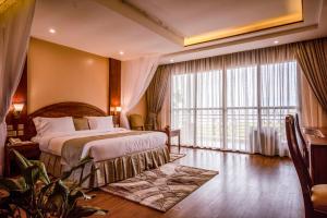 坎帕拉Kalanoga Resort的酒店客房设有一张床和一个大窗户