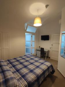 萨莱诺CASA VACANZE - ANTICO CONVENTO的一间卧室配有一张床、一张桌子和一盏灯