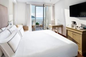 拉科鲁尼亚玛利亚皮塔美利亚酒店的卧室设有一张大白色床,享有海景