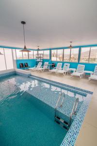 莫克瓜Hotel Costa Sol Moquegua的一个带椅子和桌子的大型游泳池