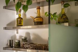 瓦莫斯Olive Lemon Biophilic House & Lush Forest Garden的上面有瓶子和植物的架子